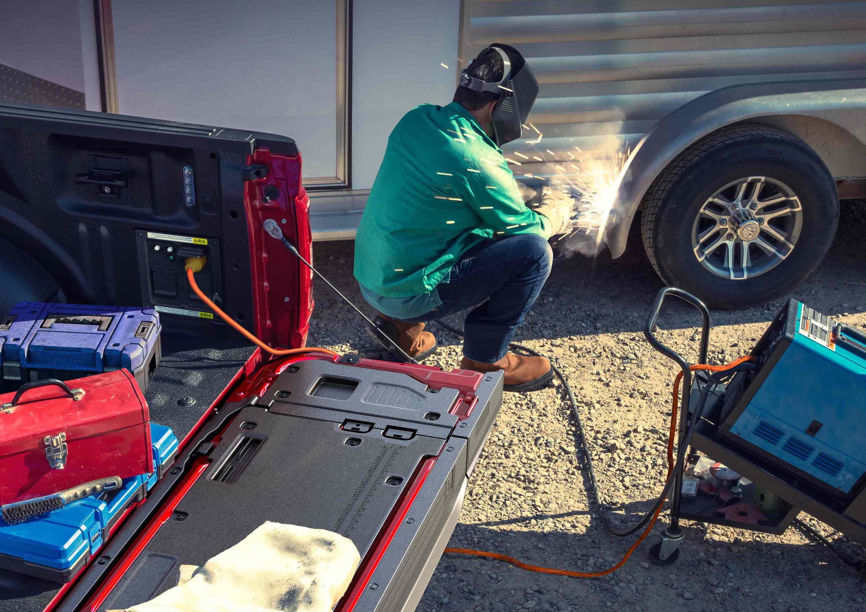 使用TIG焊机的人员，该焊机插入位于卡车床上的Pro电源板载功能